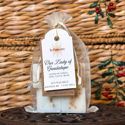 Scented wax melt packaging with a decorative tag on a woven background